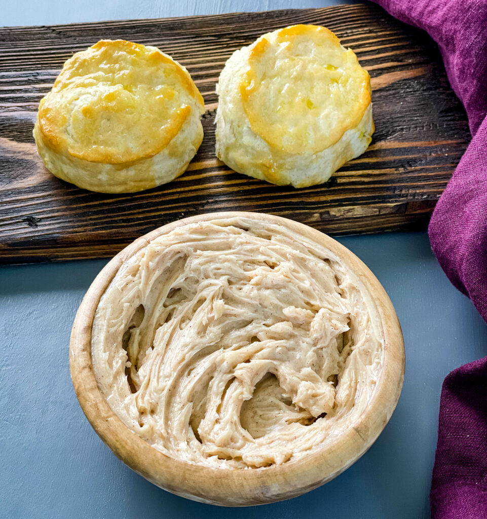 maple butter in a bowl with a plate of biscuits