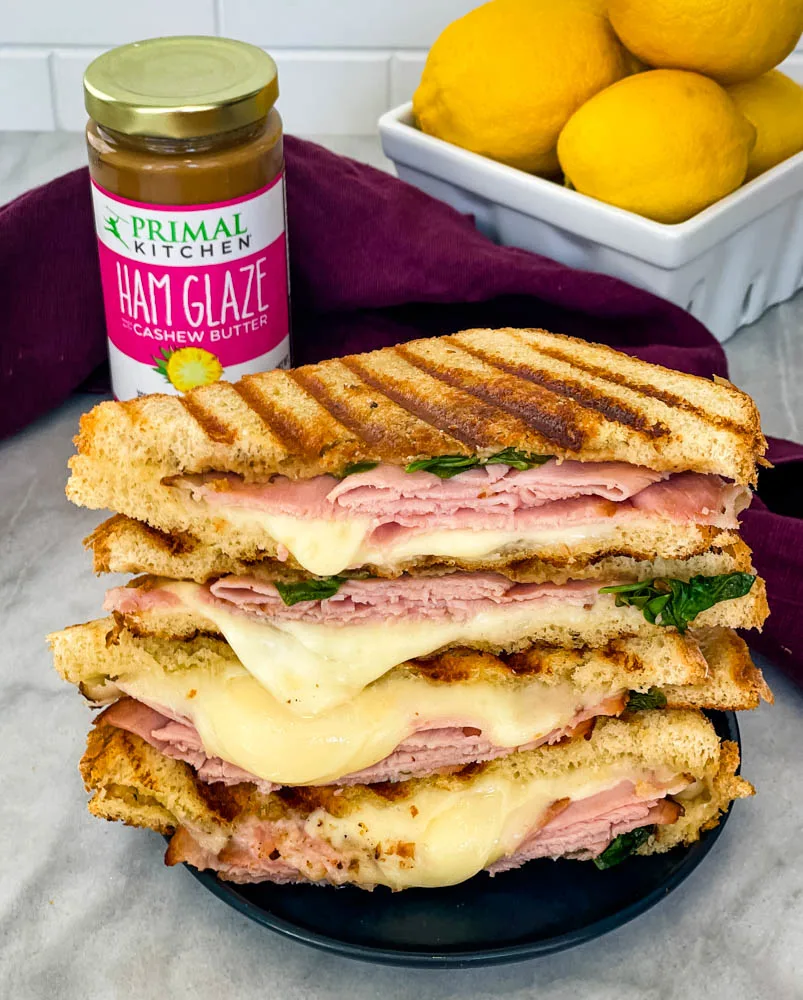 sliced ham and cheese panini sandwich on a plate