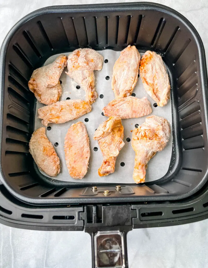 raw breaded chicken wings in a basket