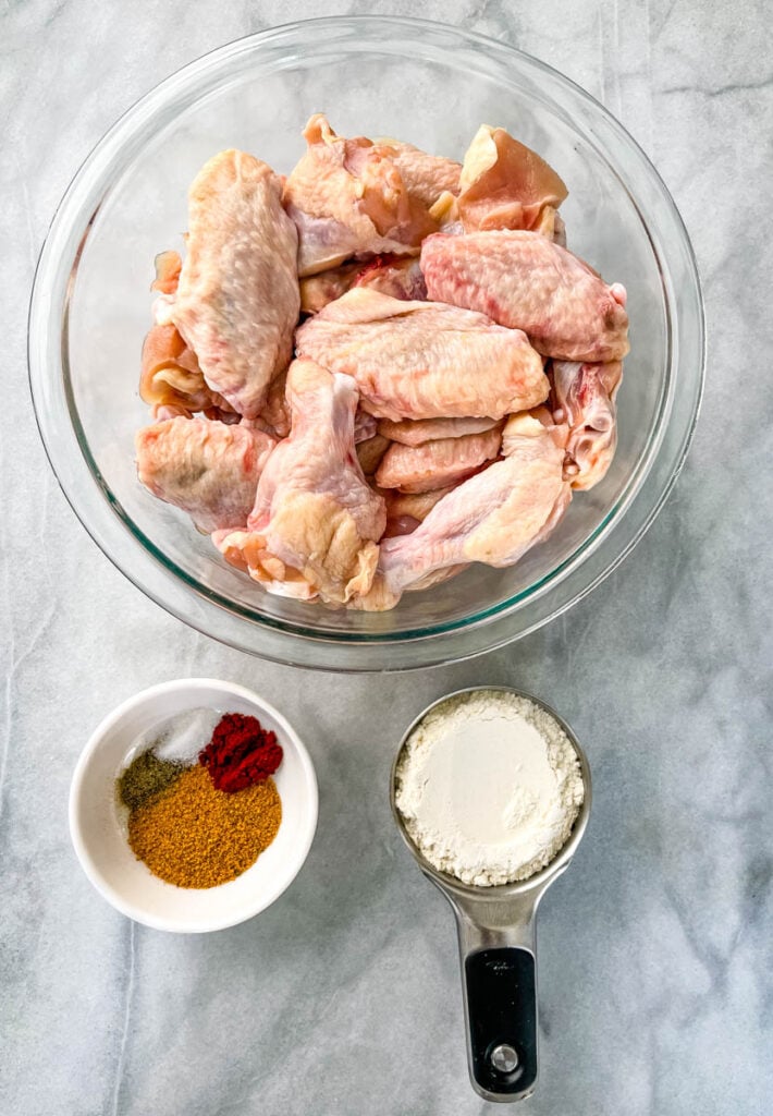 raw chicken wings in a glass bowl