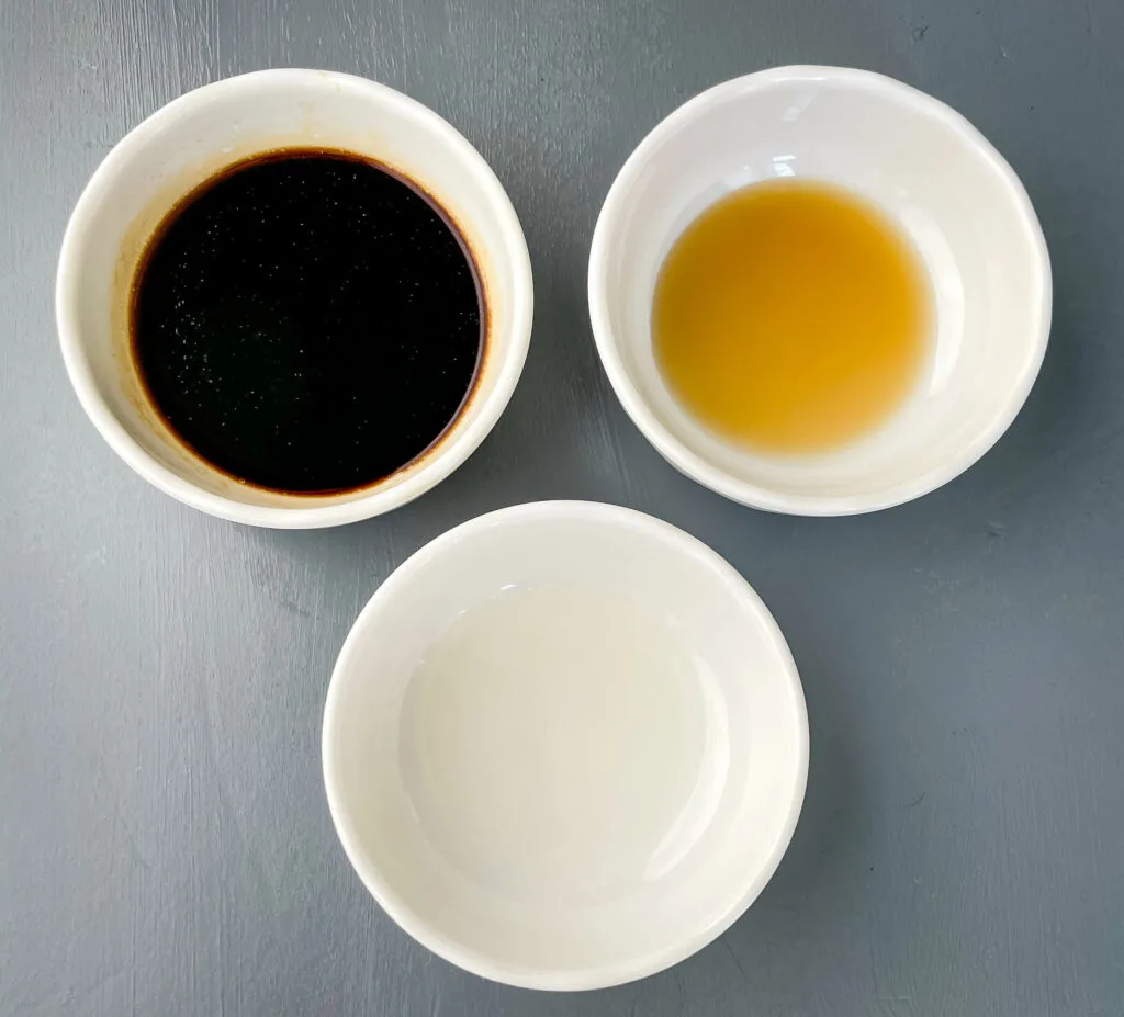 soy sauce, sesame oil, and rice wine vinegar in separate bowls