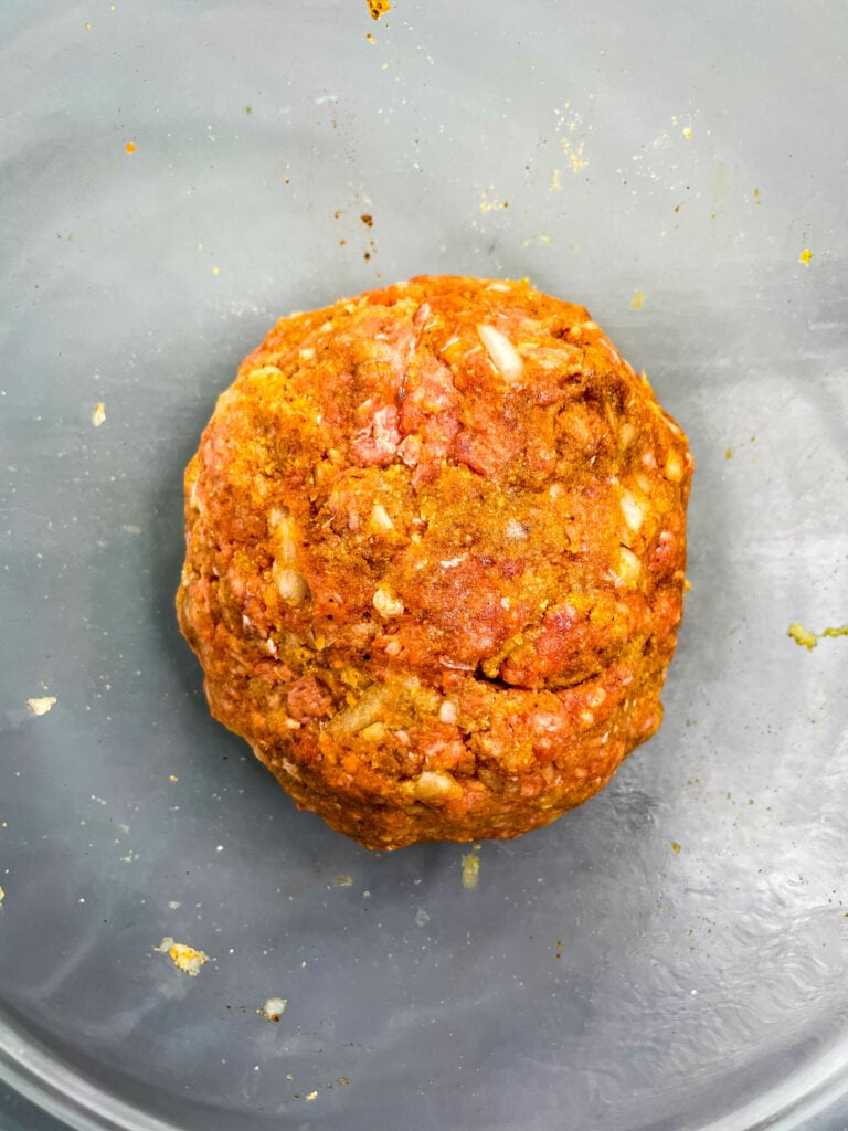 raw meatball mixture in a glass bowl