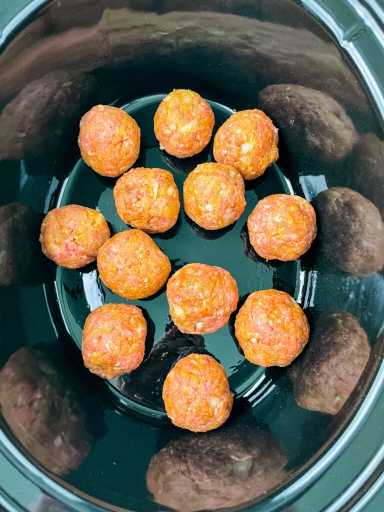 raw meatballs in a slow cooker