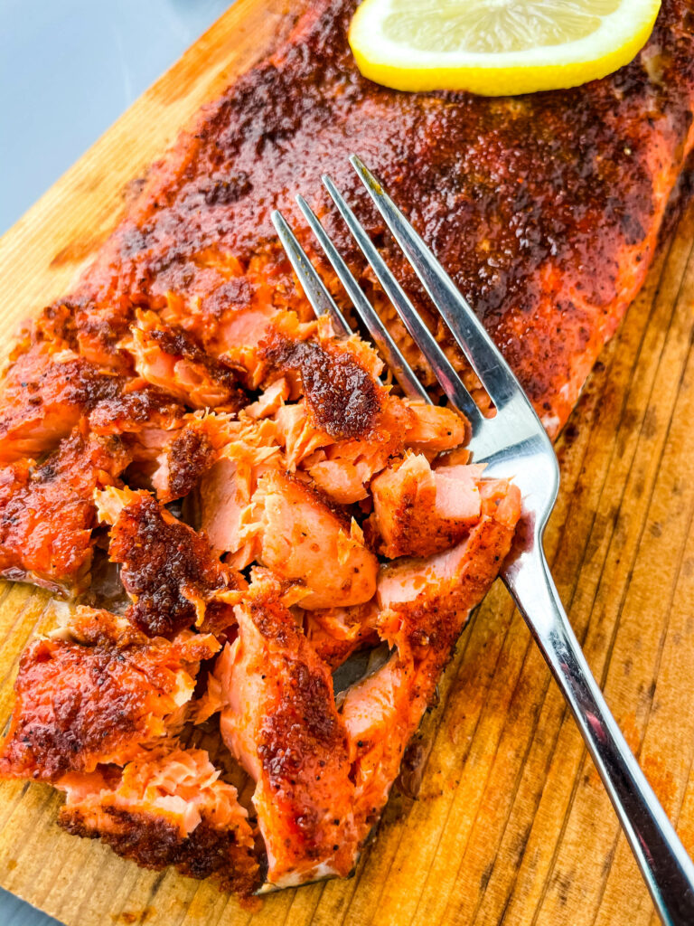 grilled salmon on a cedar plank sliced up