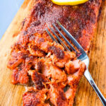 grilled salmon on a cedar plank sliced up