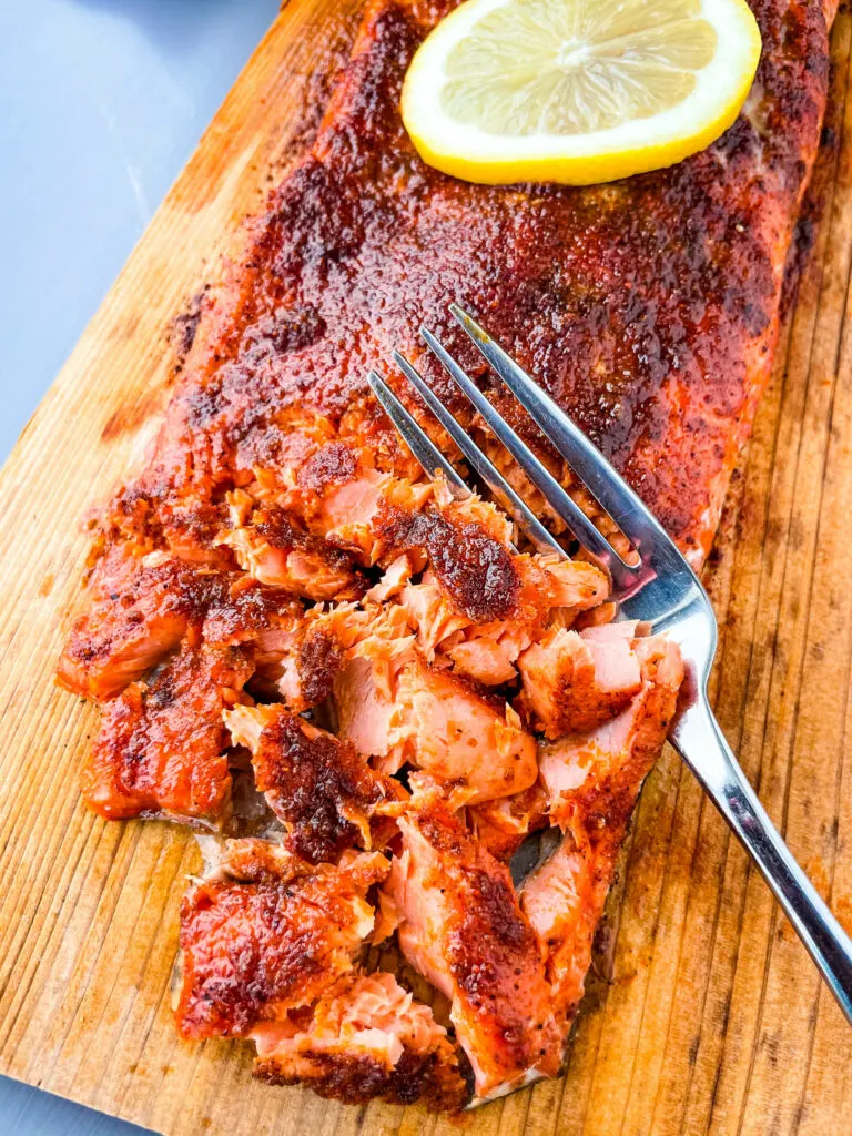 grilled salmon on a cedar plank sliced up