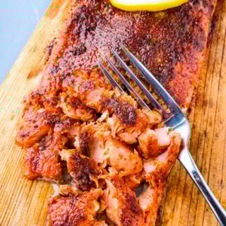 grilled salmon on a cedar plank sliced up