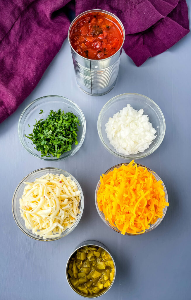 fire roasted tomatoes, fresh cilantro, chopped onions, shredded cheese, and green chilies in separate bowls