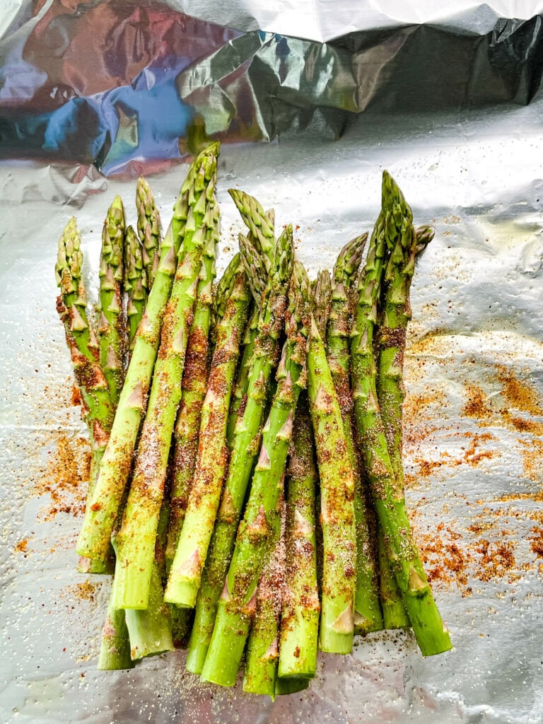 grilled asparagus sprinkled with spices in foil
