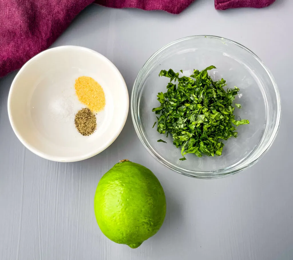 fresh chopped cilantro, a fresh lime, garlic powder, salt, and pepper in separate bowls