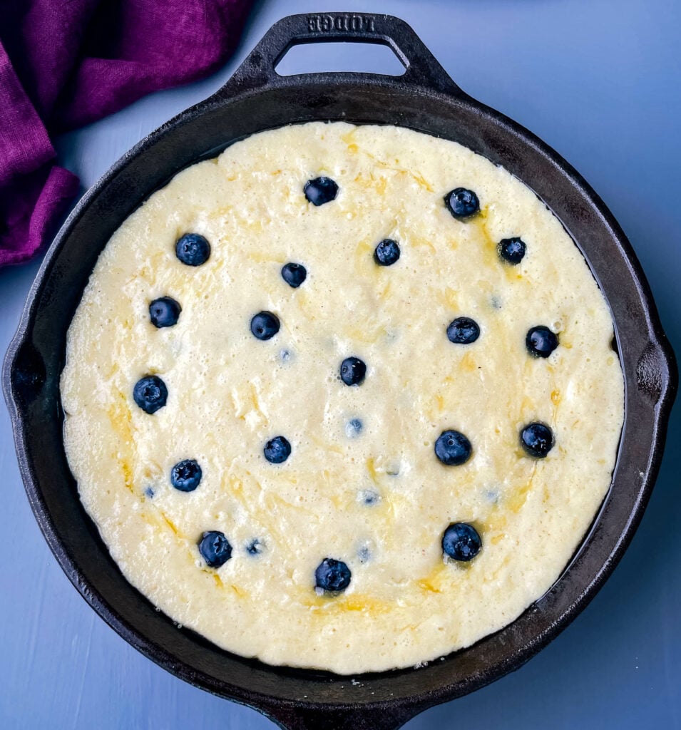 unbaked homemade blueberry cornbread in a cast iron skillet