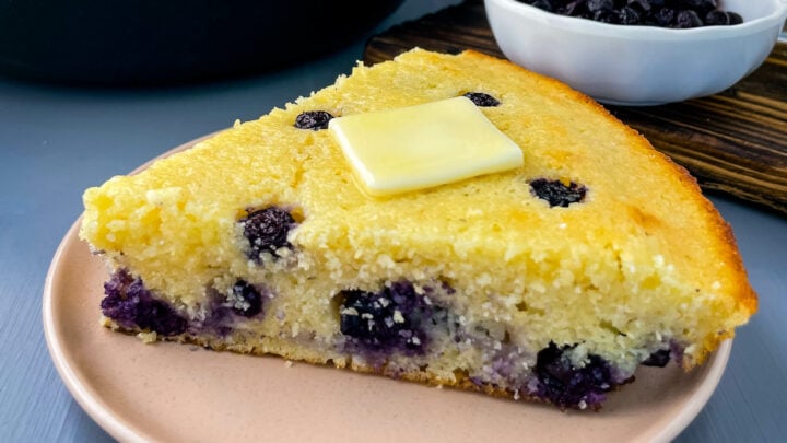 a slice of homemade blueberry cornbread on a plate