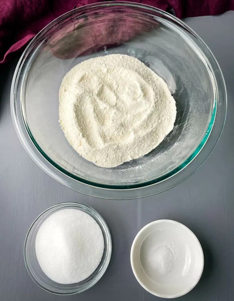 self rising cornmeal, sweetener, and salt in separate glass bowls