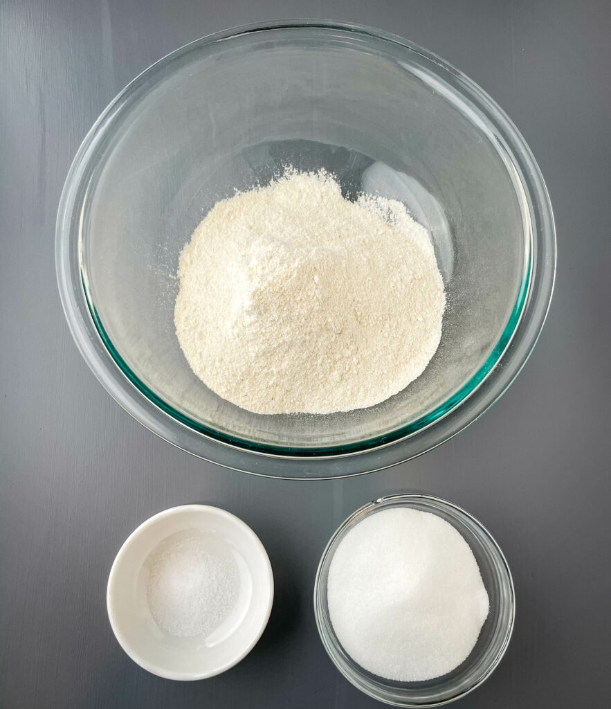 self rising cornmeal, salt, and sweetener in separate glass bowls