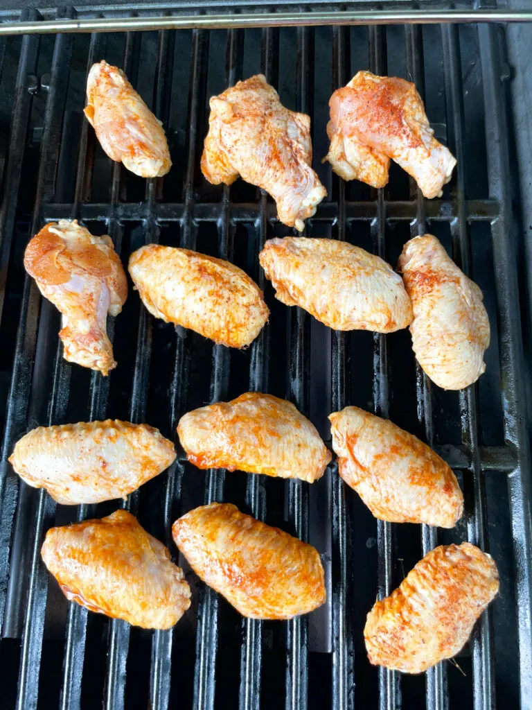 raw chicken wings on a grill