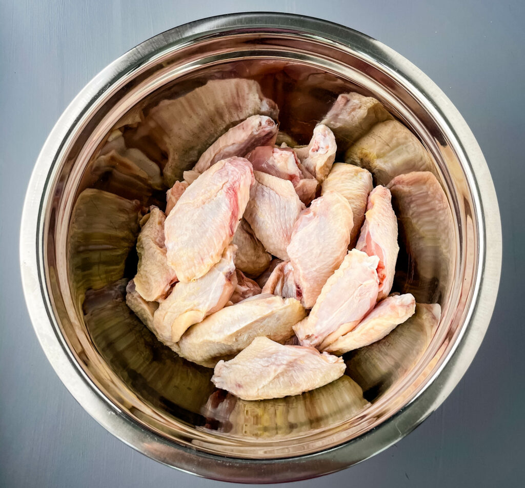 raw chicken wings in a large bowl