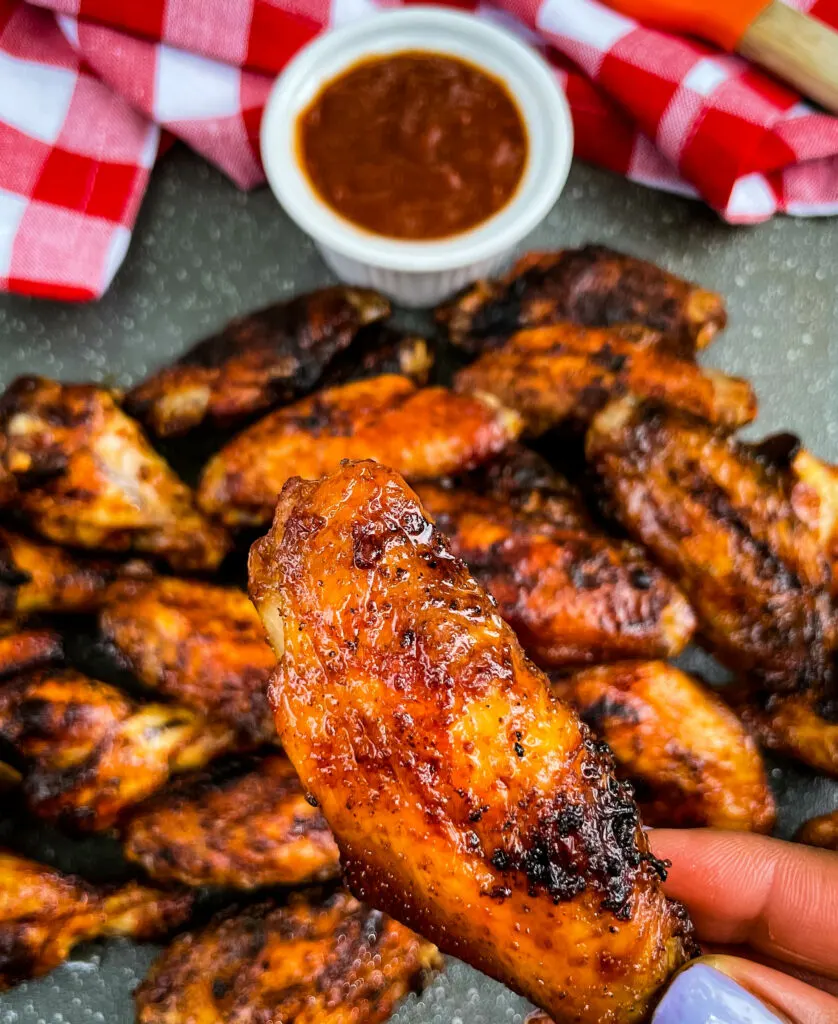 grilled chicken wings on a plate with BBQ sauce