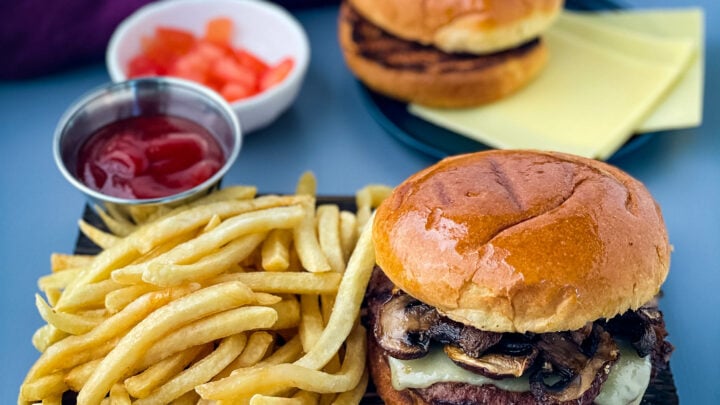 mushroom swiss burger on a plate with French fries