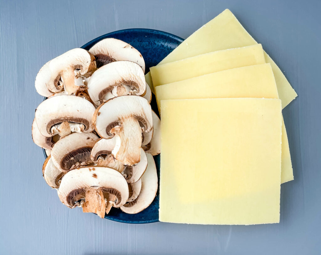 mushrooms and swiss cheese on a plate