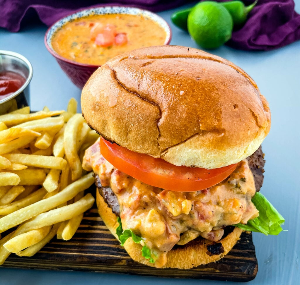 queso burgers on plate with French fries