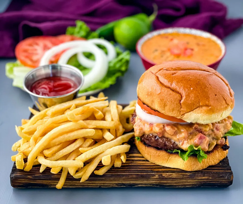 queso burgers on plate with French fries