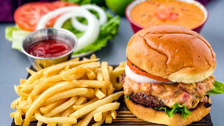 queso burgers on plate with French fries