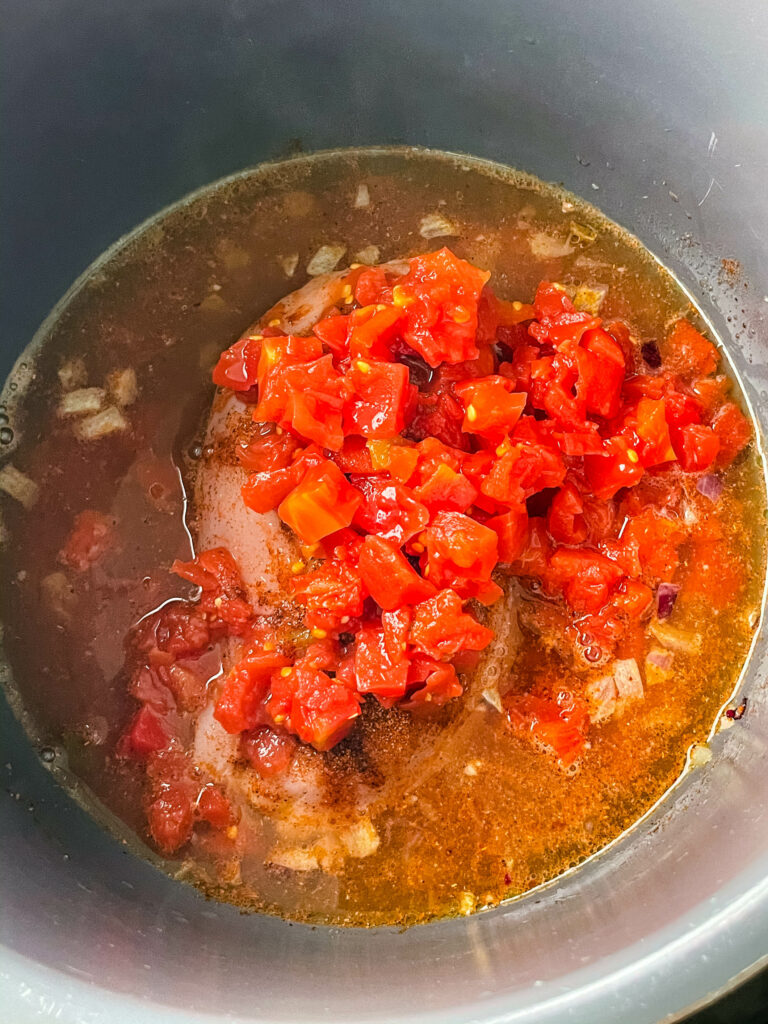 chicken breast in an Instant Pot with diced tomatoes and chilies
