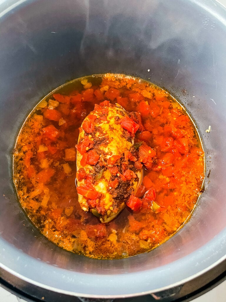 chicken breast in an Instant Pot with diced tomatoes and chilies