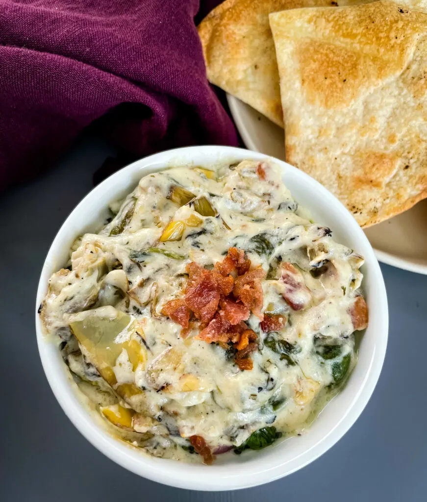 bacon spinach artichoke dip in separate bowls with chips