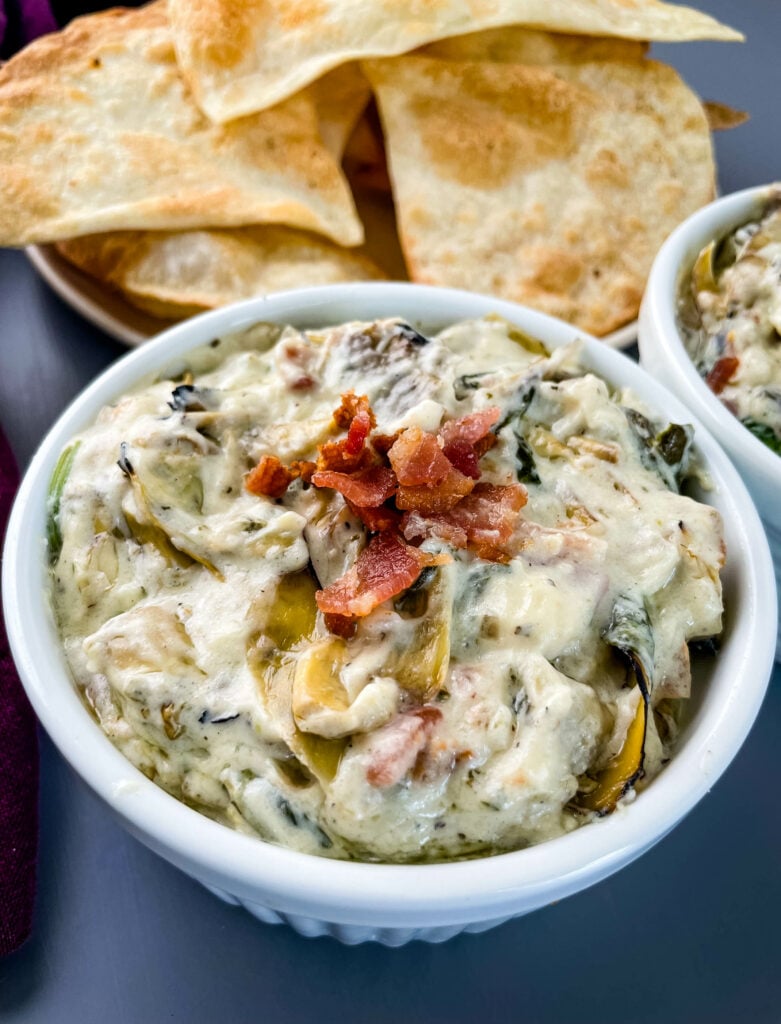 bacon spinach artichoke dip in separate bowls with chips