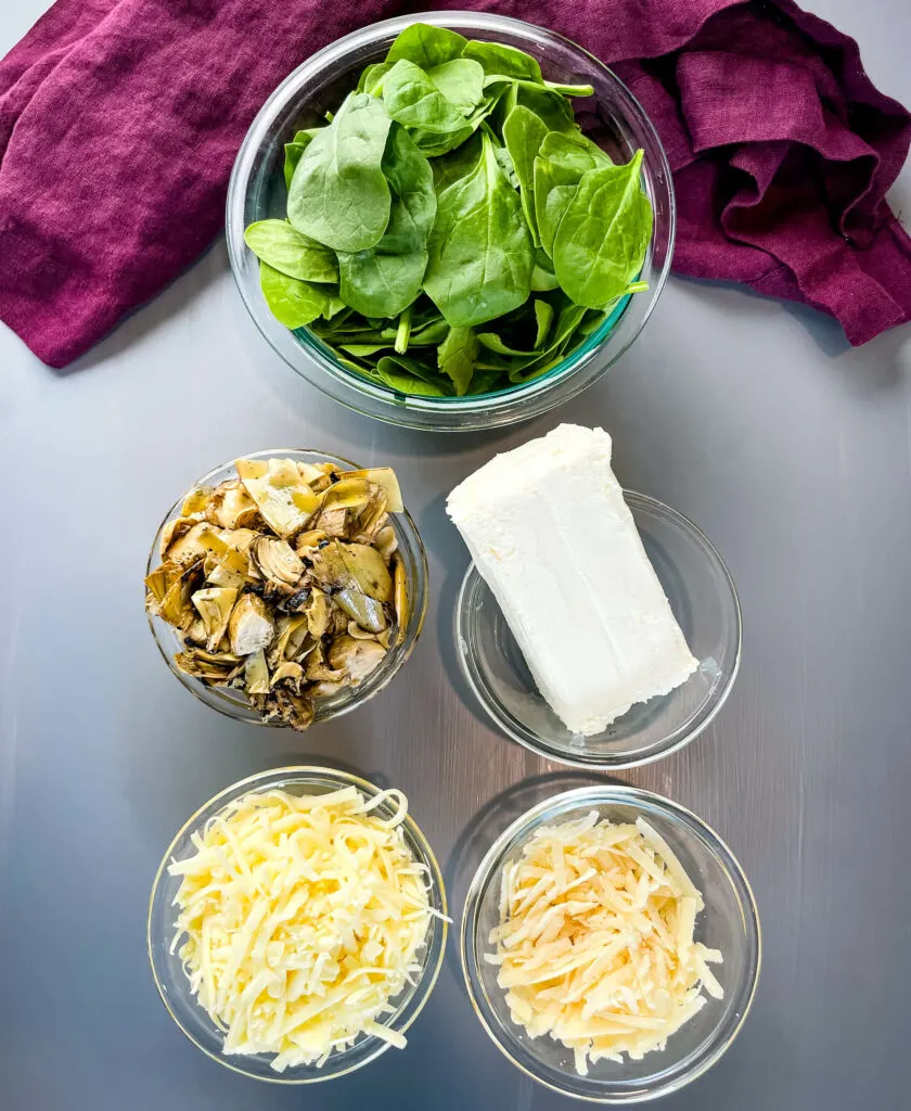 fresh spinach, artichokes, cream cheese, mozzarella, and Parmesan in separate bowls