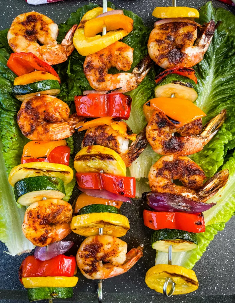 BBQ grilled shrimp skewers on a bed of lettuce