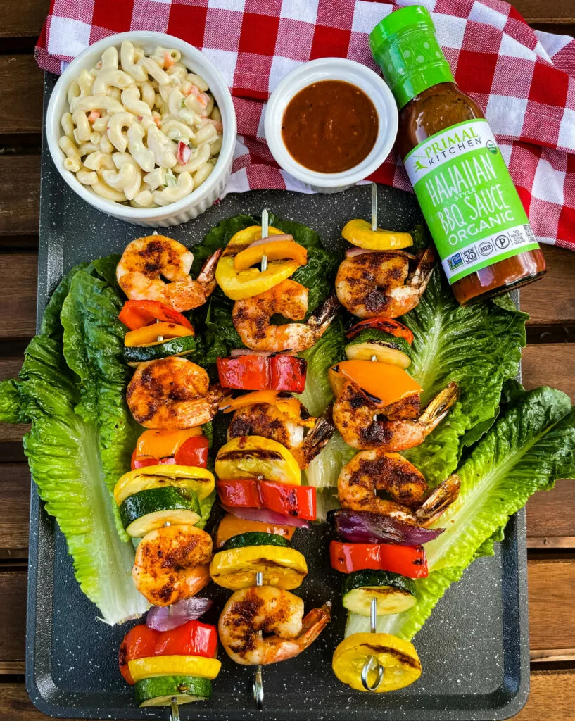 BBQ grilled shrimp skewers on a bed of lettuce