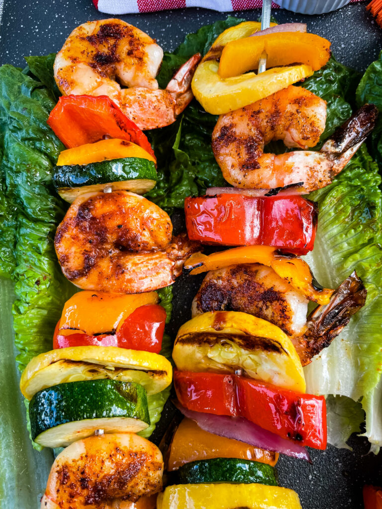 BBQ grilled shrimp skewers on a bed of lettuce