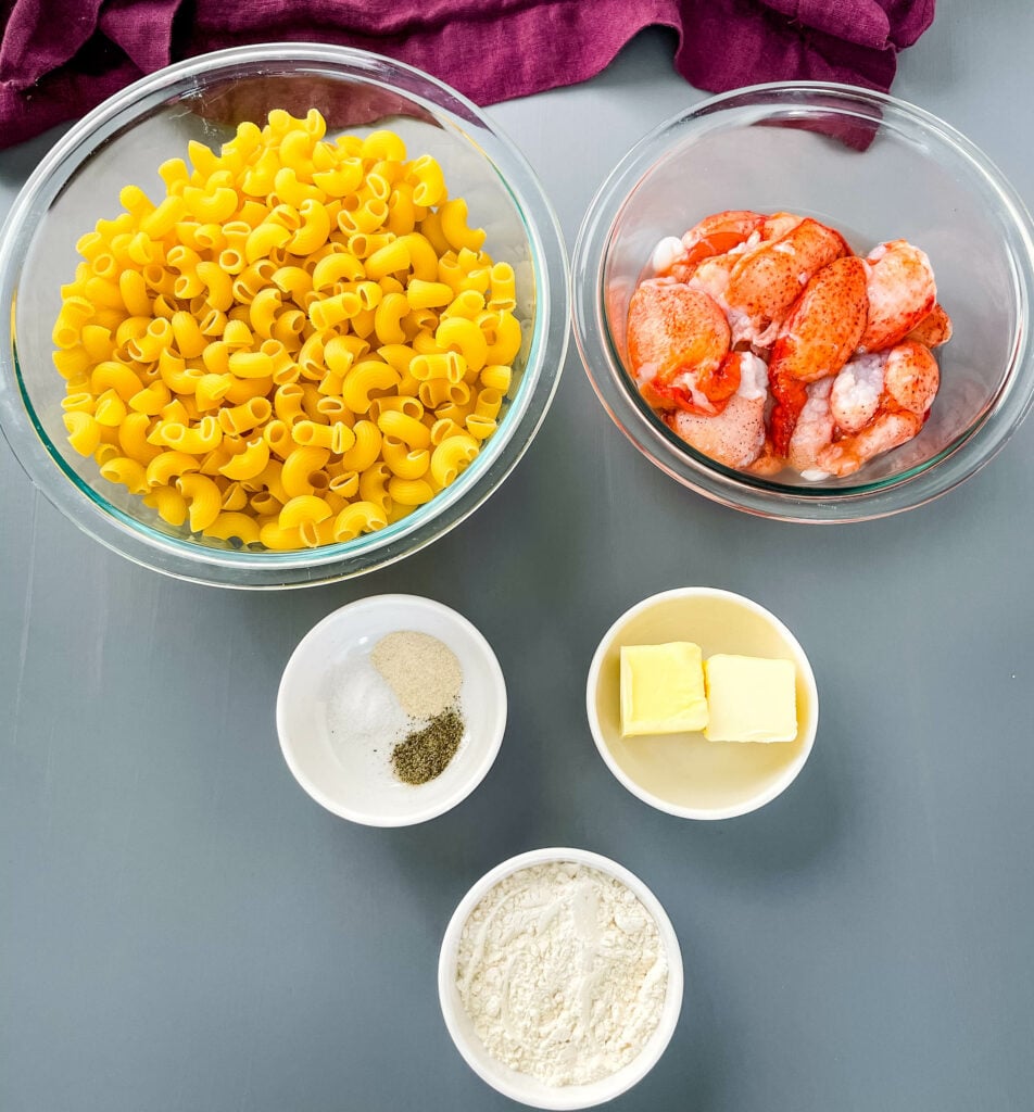 macaroni pasta, raw lobster, butter, flour, and seasonings in separate bowls