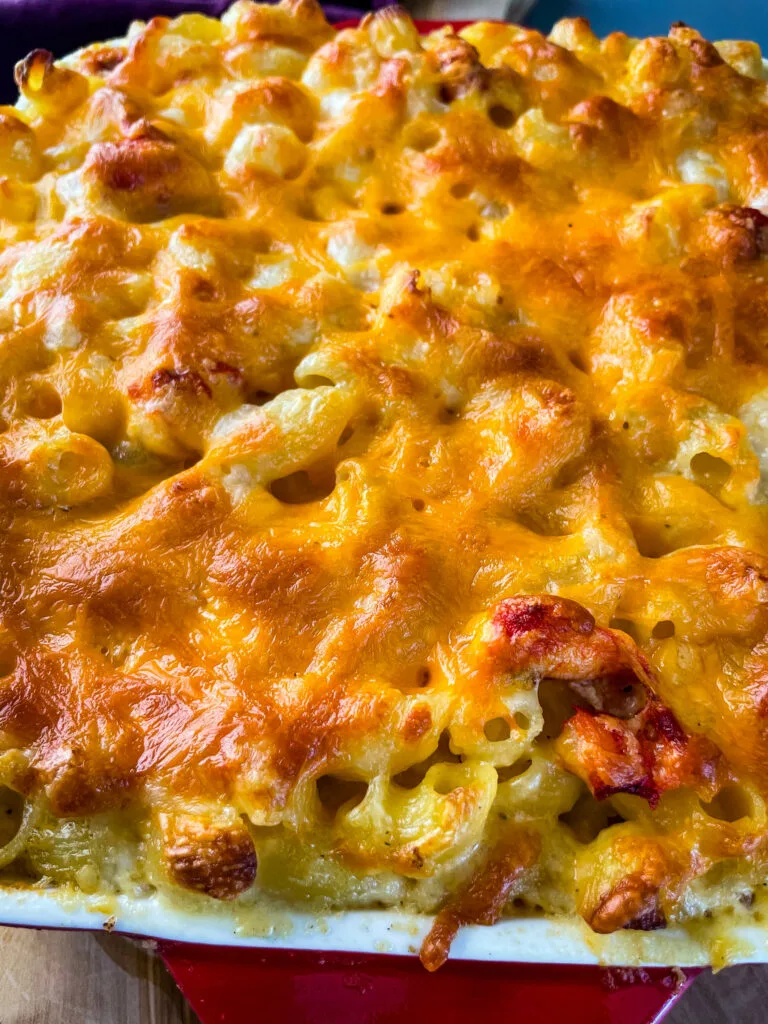 close up view of lobster mac and cheese in a baking dish