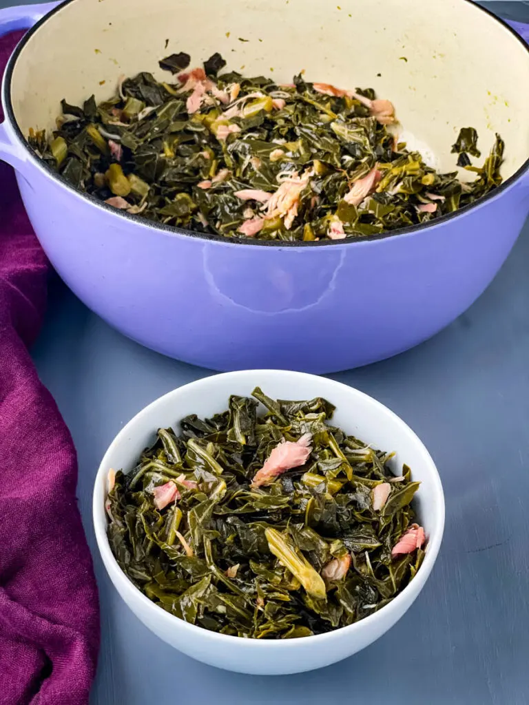 southern collard greens in a white bowl and a purple pot