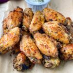 ranch chicken wings on a plate with ranch dressing