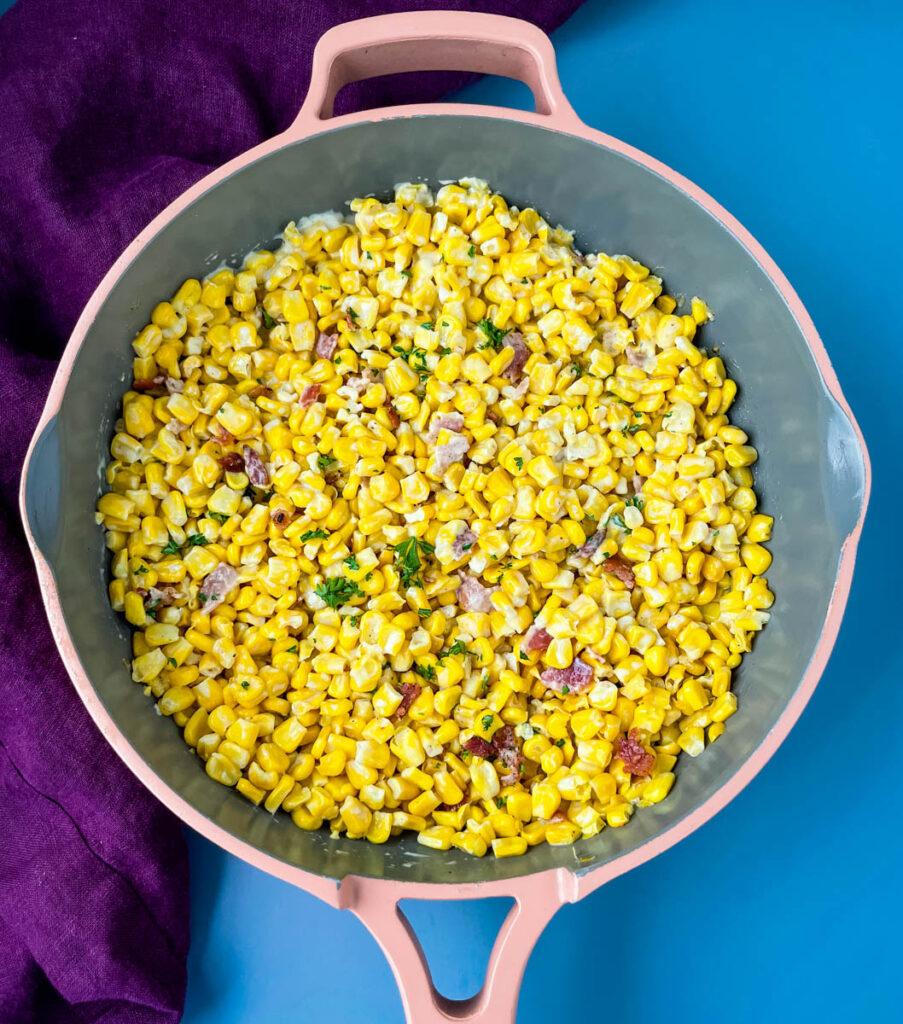 homemade creamed corn in a pink skillet