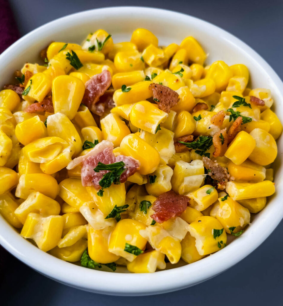 homemade creamed corn in a white bowl