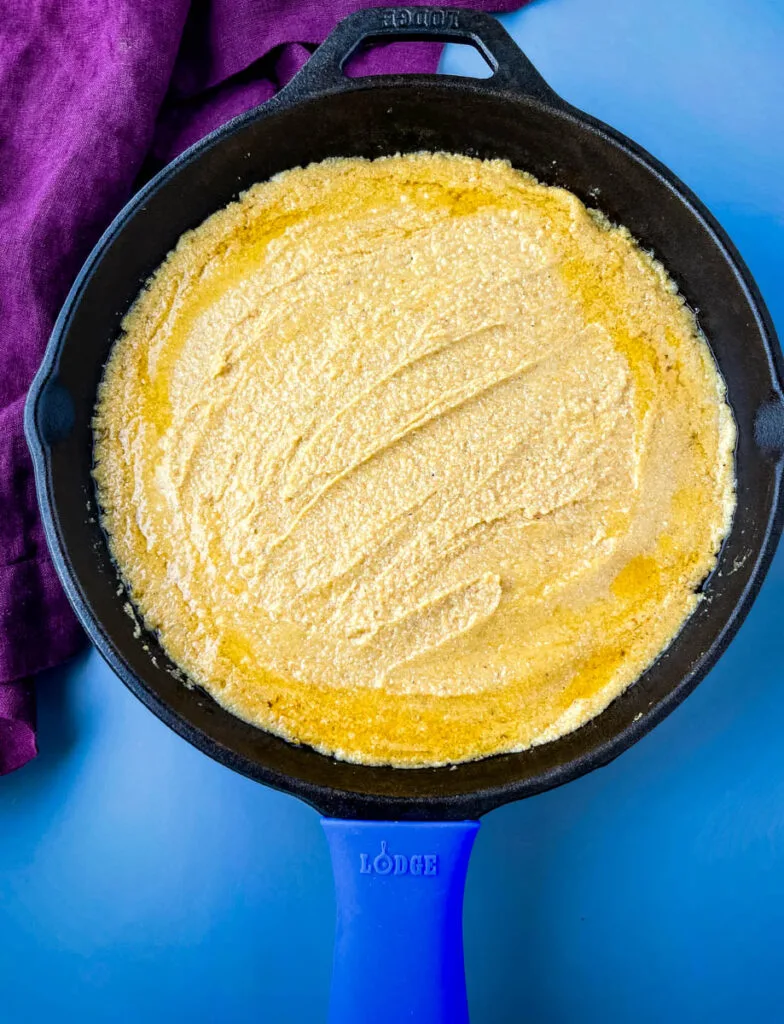 unbaked pumpkin cornbread in a cast iron skillet