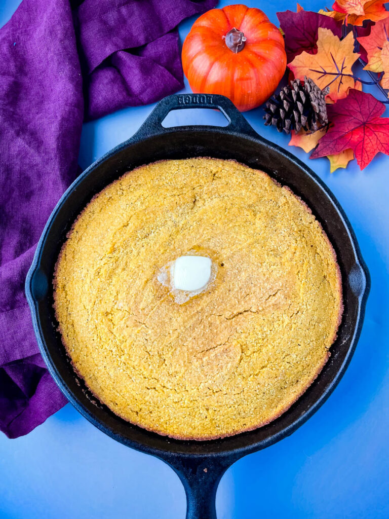 pumpkin cornbread in a cast iron skillet