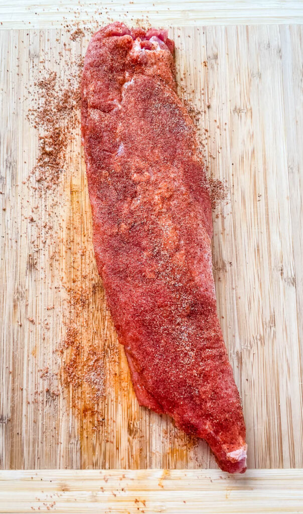 seasoned pork tenderloin on a cutting board