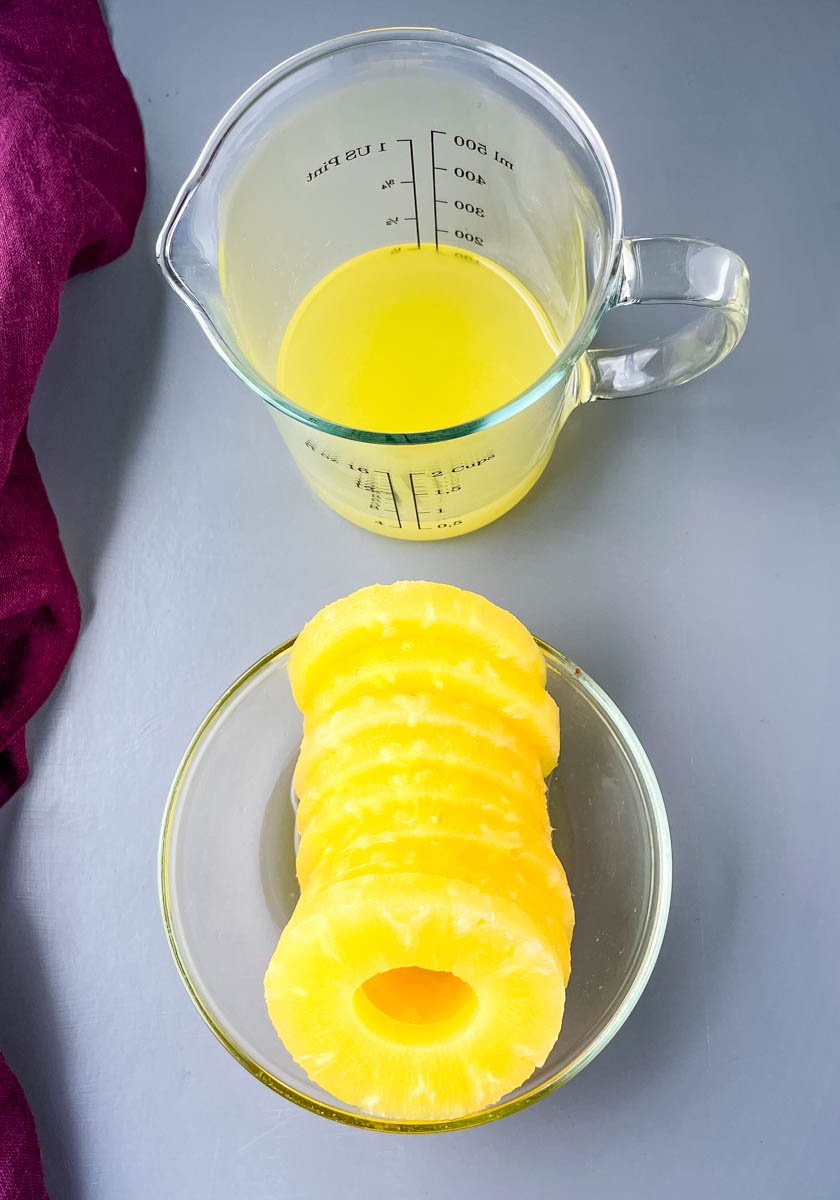 fresh pineapples and pineapple juice in a cup