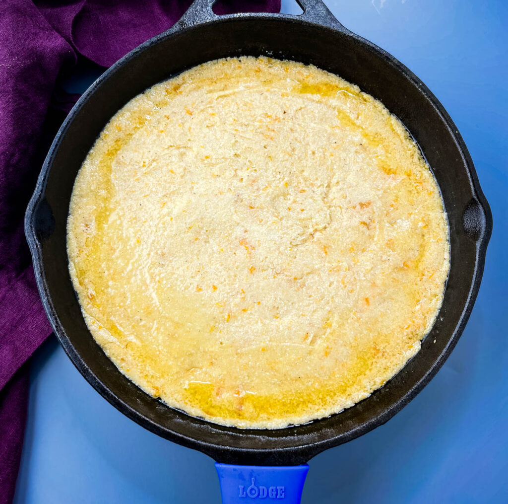 sweet potato cornbread batter in a cast iron skillet