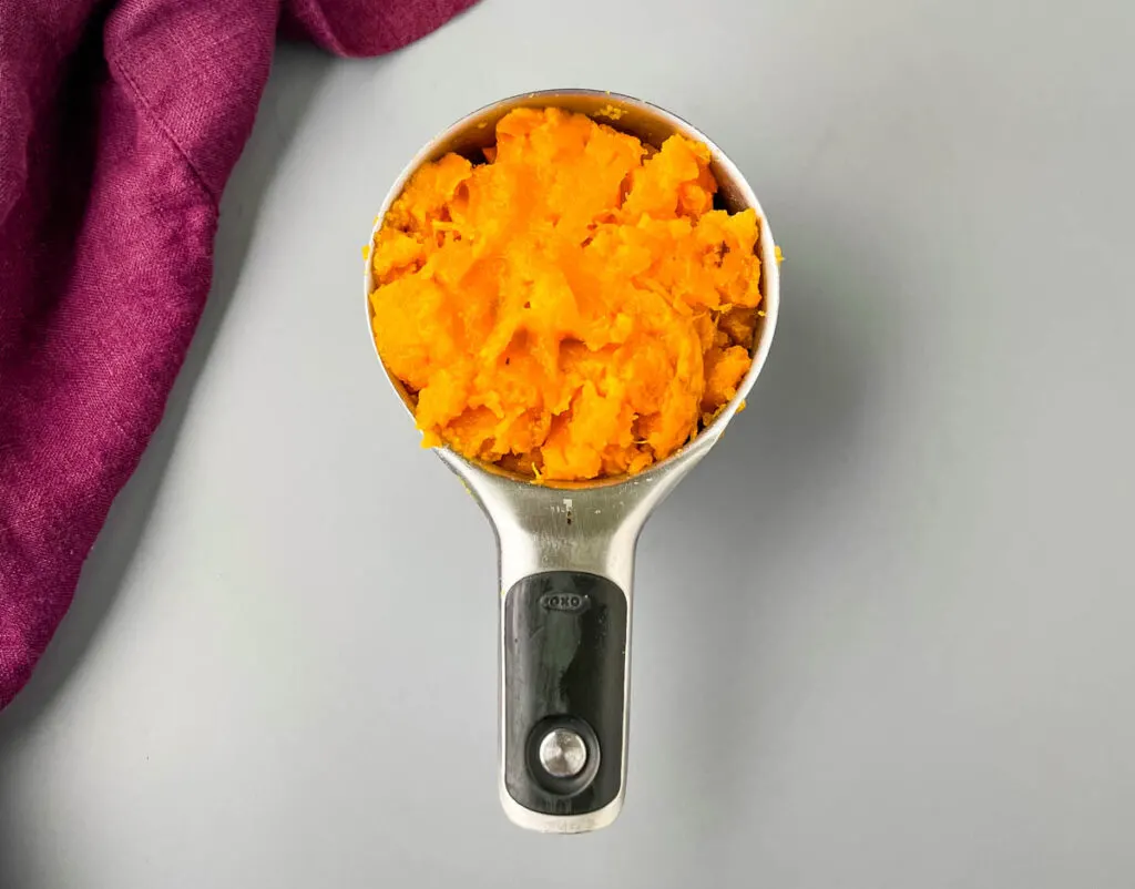 mashed sweet potatoes in a measuring cup