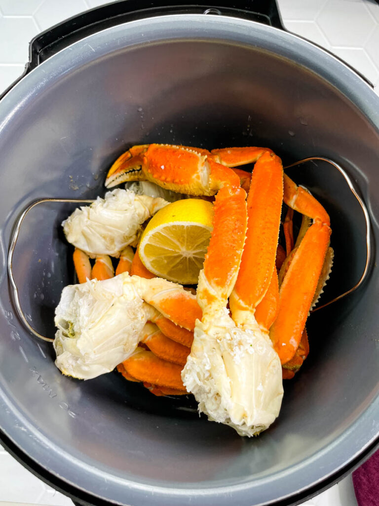 crab legs in an Instant Pot with fresh lemon