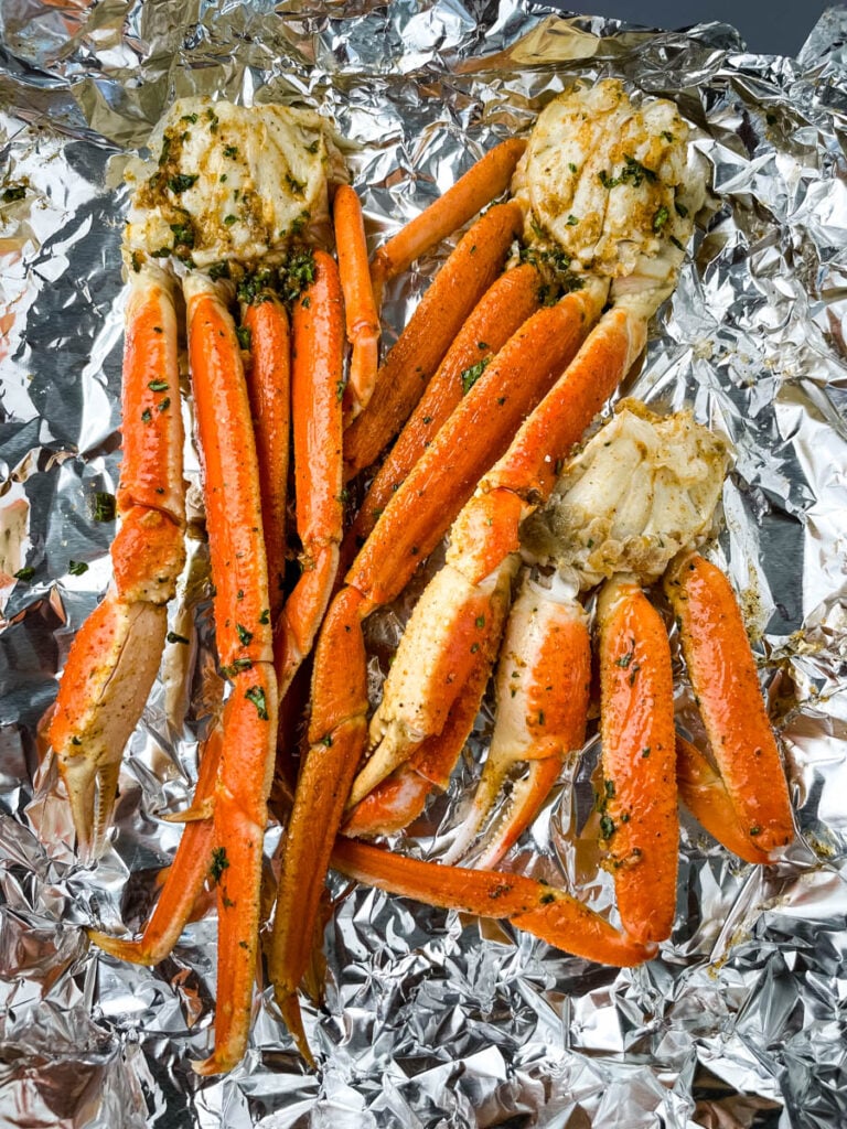 fresh crab legs on foil with garlic butter