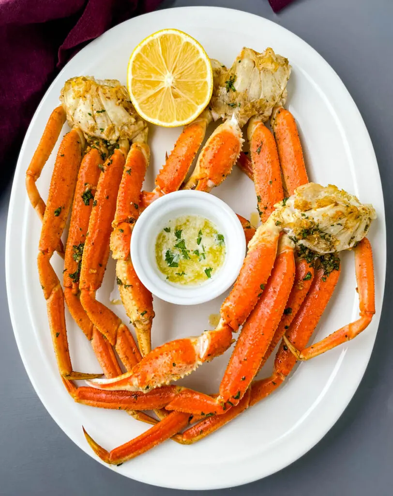 air fryer crab legs on a white plate with butter