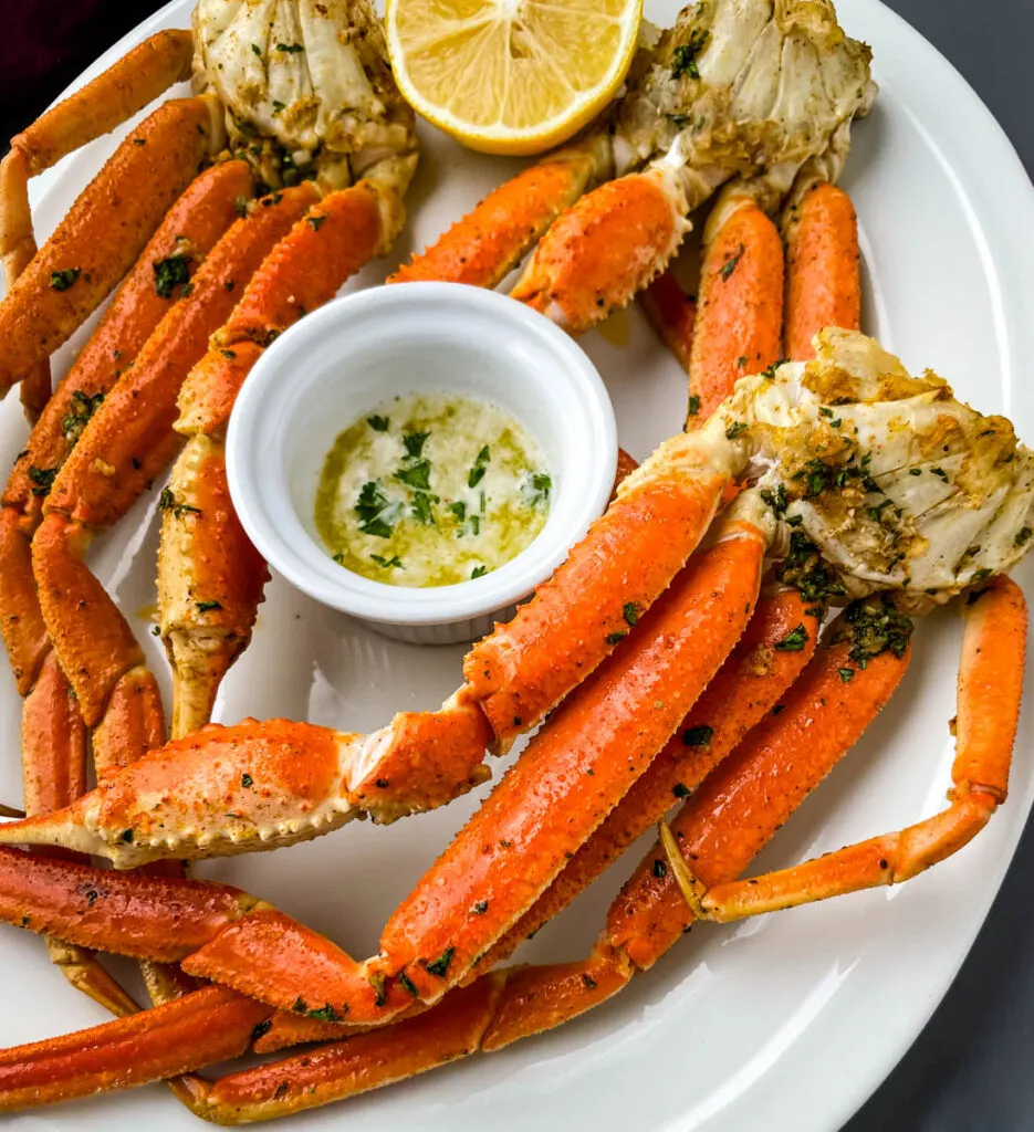 air fryer crab legs on a white plate with butter